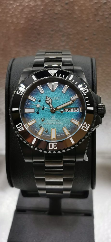 Seiko Prospex diver with black case and turquoise dial