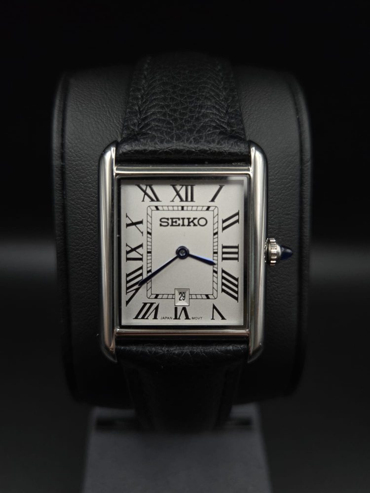 Steel Seiko dress watch with rectangular white Roman-numeral dial and black leather strap