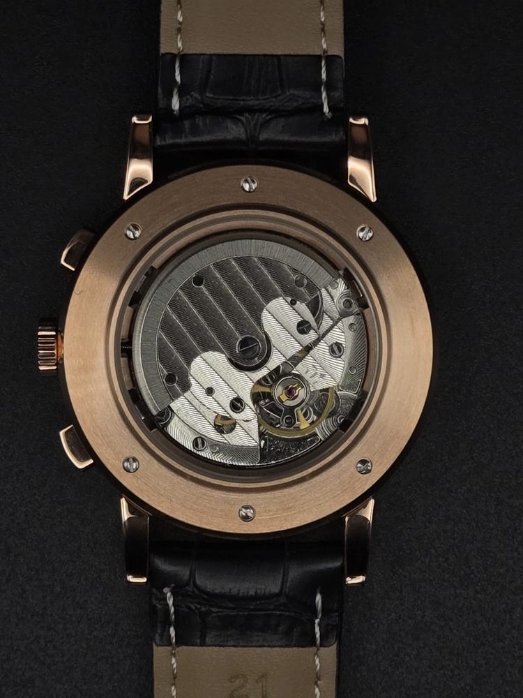 Exhibition caseback of a custom rose-gold chronograph revealing the automatic movement